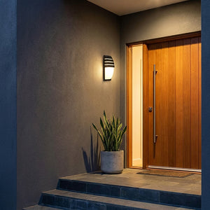 Applique murale Lutéa éclairant une entrée moderne avec porte en bois